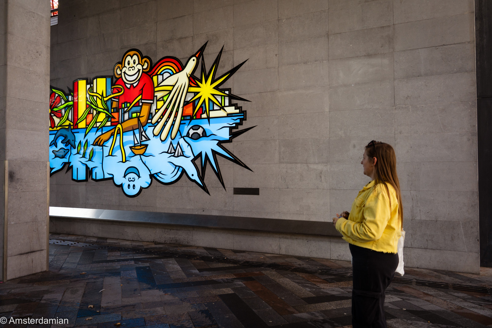 Our guide showing us a colourful mural close to Almere Train Station