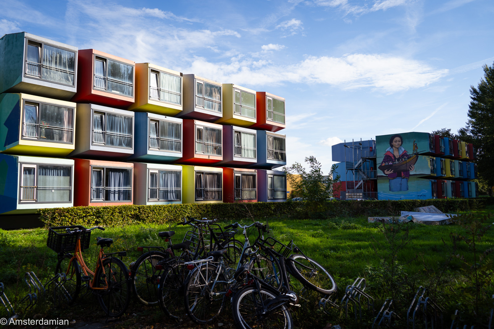 Bikes parked in front of colourful stacked homes in Almere