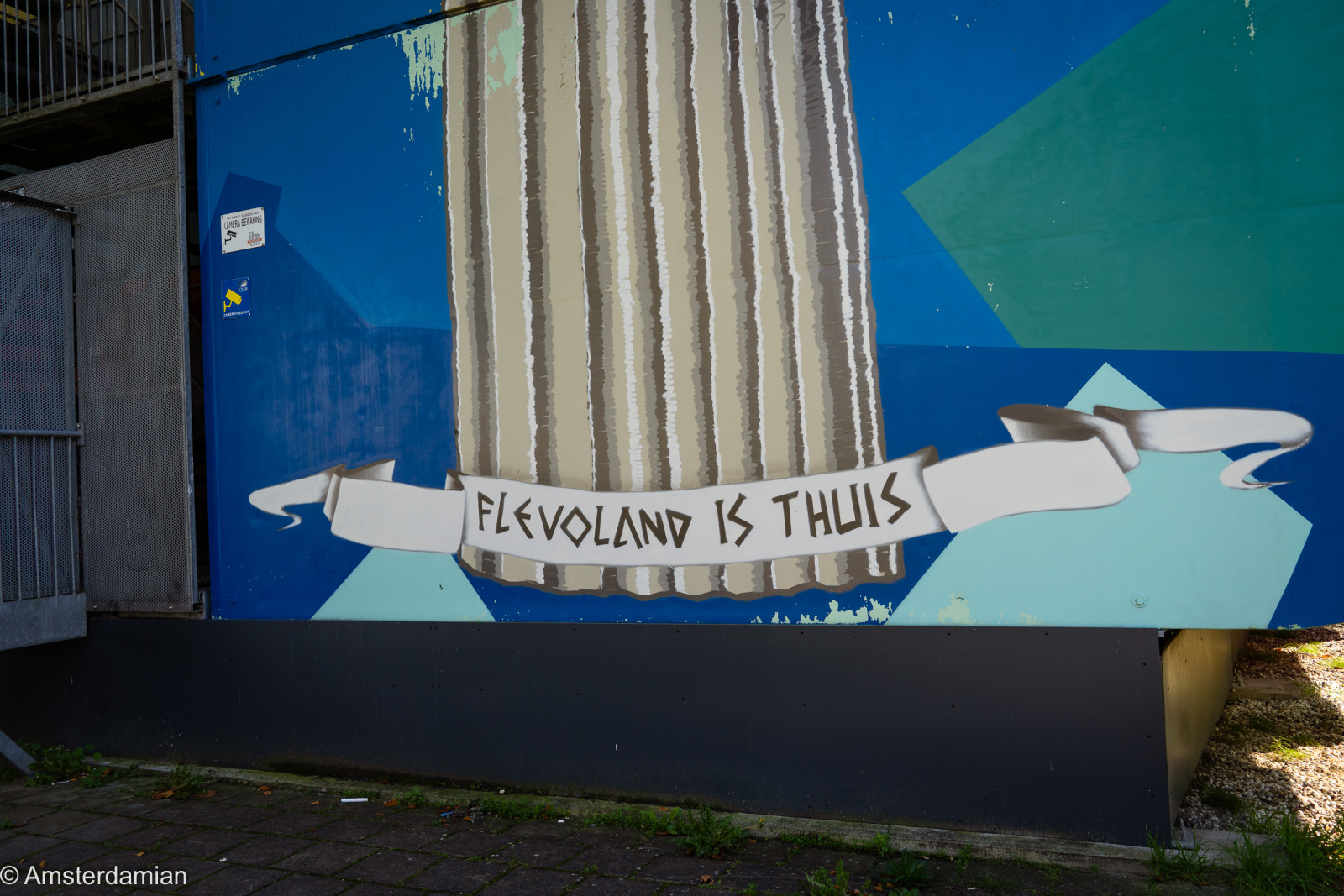Mural with a 'Flevoland is thuis' banner on a building in Almere
