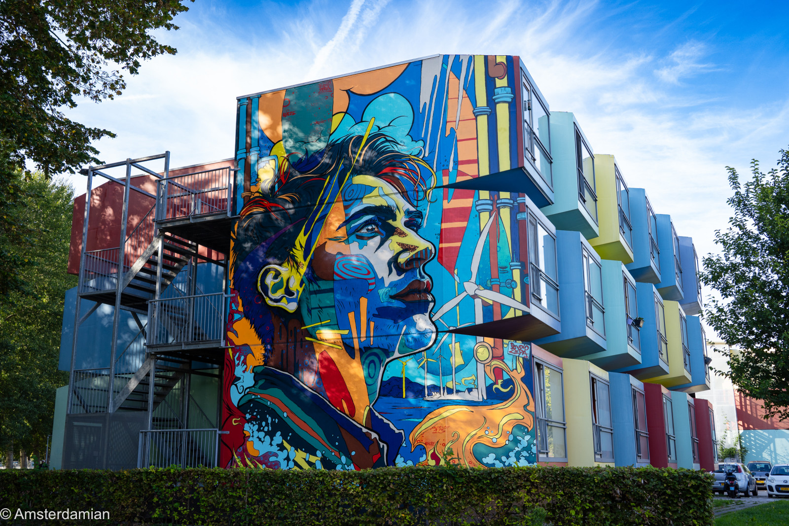 Large portrait mural of a man's face on a building in Almere