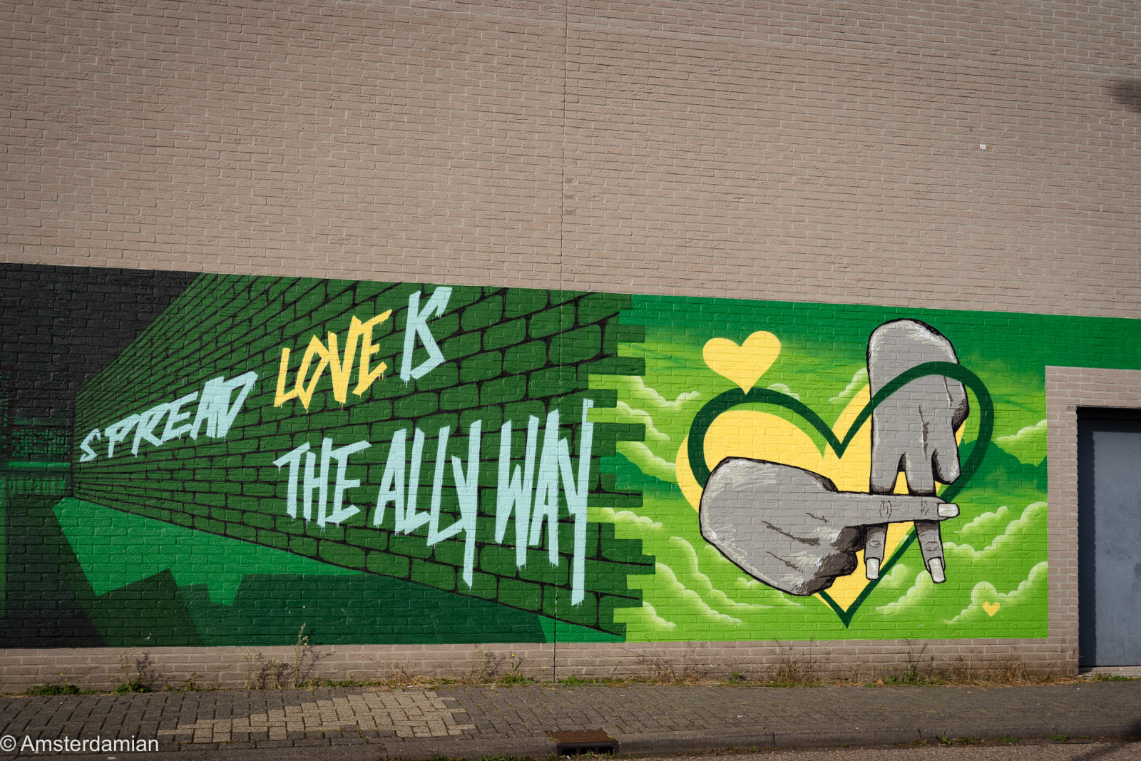 Green 'Spread love is the Ally way' mural in Almere city centre
