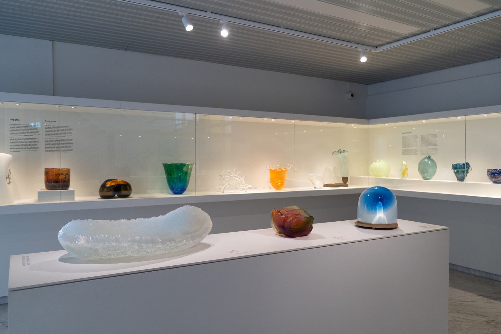 Glass art collection in display cases at Museum JAN in Amstelveen
