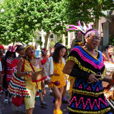 Dancers in handmade crochet koto dresses at the Bigi Spikri parade, Amsterdam