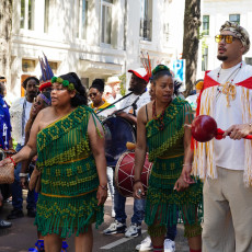 Dancers in green fringed costumes at the Bigi Spikri parade, Amsterdam