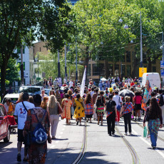 Crowds join the Bigi Spikri parade through central Amsterdam on Keti Koti