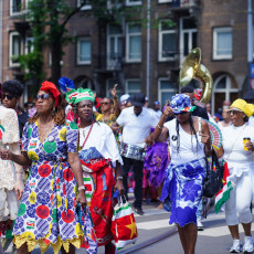 Women in koto dress marching in the Bigi Spikri parade, Amsterdam