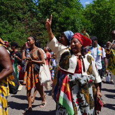 Dancers and a trumpeter in the Bigi Spikri parade, Amsterdam, on Keti Koti