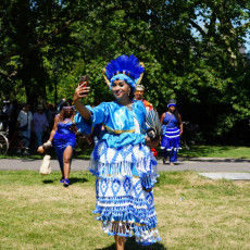 Dancer in a blue feather headdress and koto dress at Bigi Spikri, Amsterdam