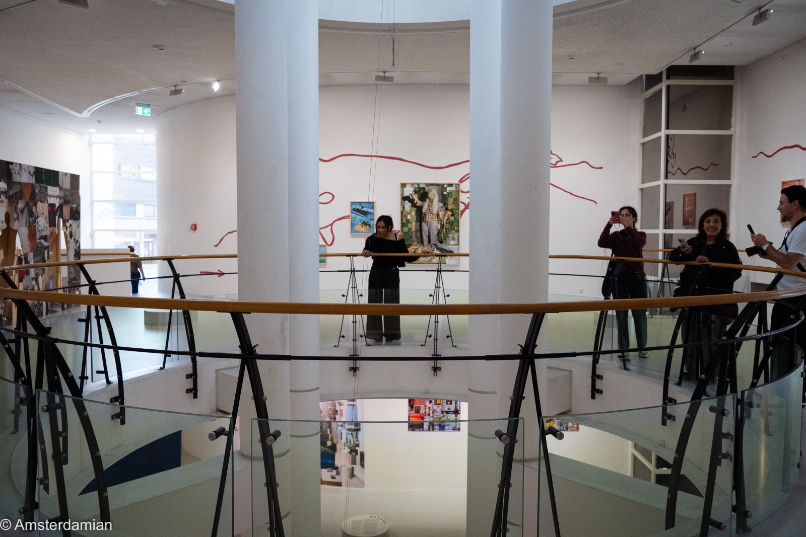 Visitors on the round gallery around the atrium at Fotomuseum Hilversum