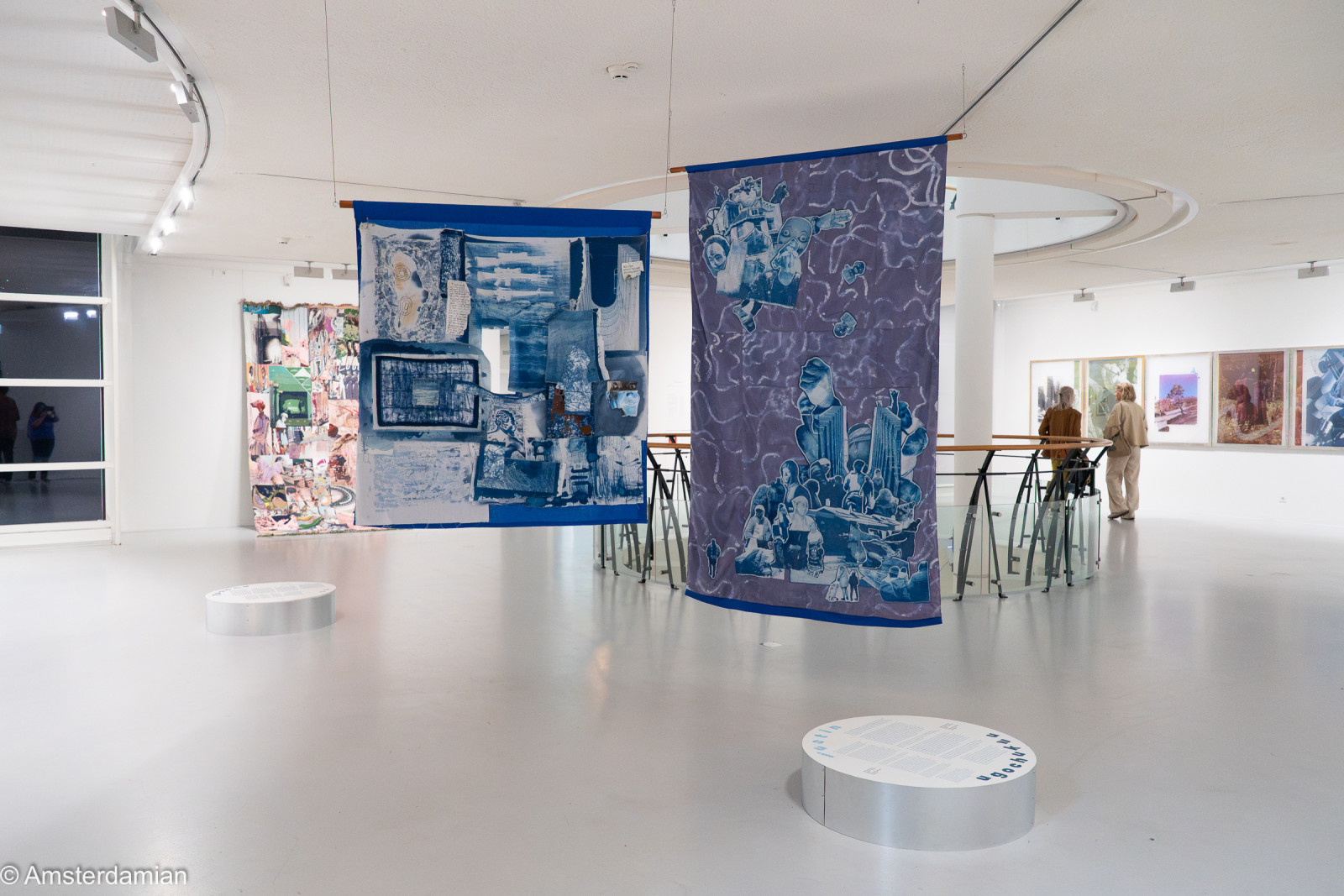 Blue cyanotype textiles hanging in the Layered Realities exhibition