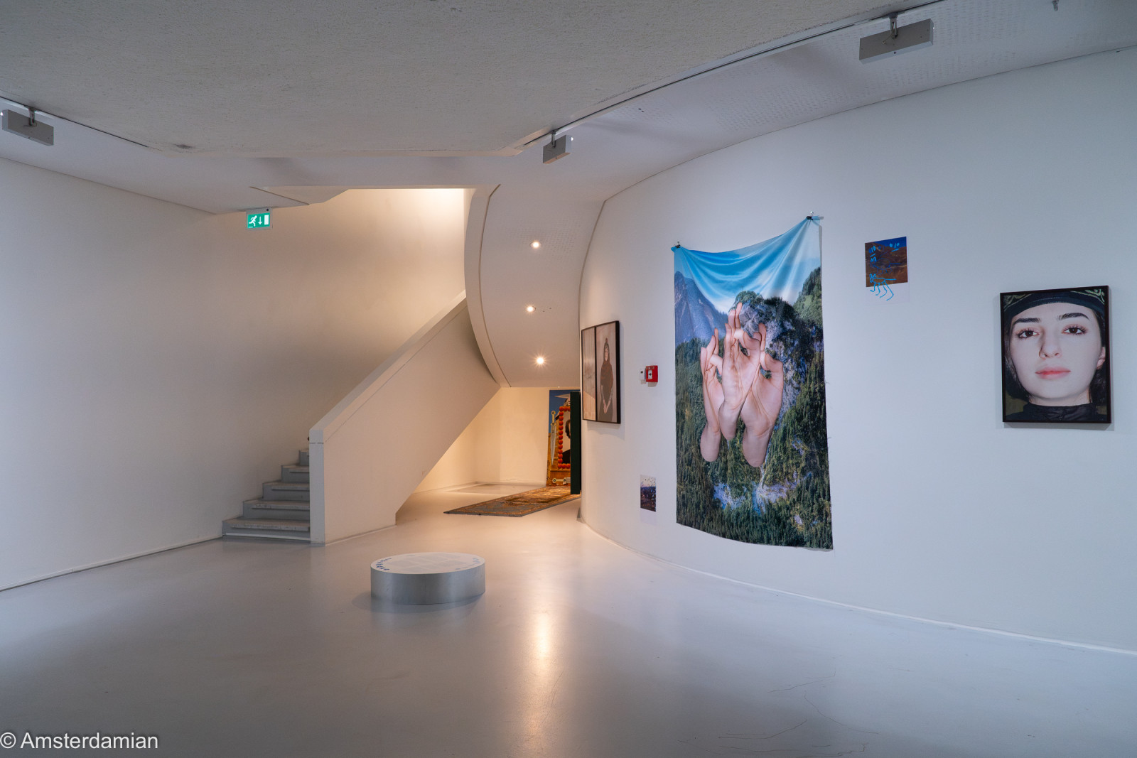Gallery with a large photo collage of hands and a portrait, Fotomuseum Hilversum