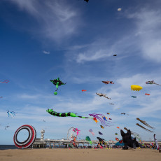 Colourful kites above Scheveningen beach, with De Pier behind