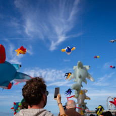 Visitor photographing the kites with his phone