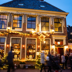 Passers-by outside Restaurant Oudejans, a 1660 building on De Rijp's main street