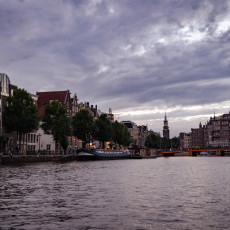 Canal houses and a tower at dusk, from an Amsterdam canal cruise
