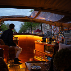 Guests on board an evening canal cruise in Amsterdam