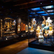 Lit case of ships' figureheads and carved ornaments at the maritime museum