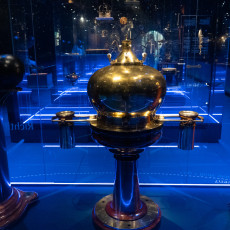 Brass ship's compass housing in the blue-lit navigation gallery