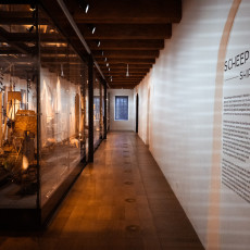Ship models gallery at Het Scheepvaartmuseum, with cases along the corridor