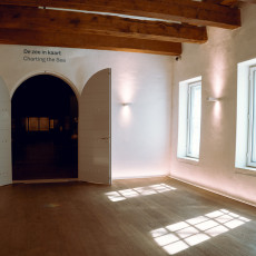 Doorway to the Charting the Sea gallery, with sunlight on the wooden floor