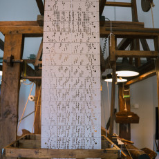 Punch cards feeding a Jacquard loom at the TextielMuseum