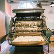 A carding machine filled with raw wool at the TextielMuseum