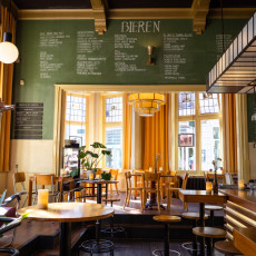 A cafe interior with a chalkboard beer menu