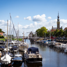 Boats in Veere harbour with the town hall tower behind