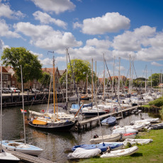 Sailing boats in Veere marina with the town behind