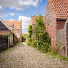 Cobbled lane between old brick houses in Veere