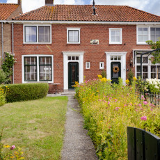 Front gardens full of flowers along a street in Veere