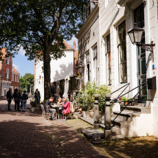Tree-lined street with a small terrace in Veere
