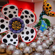 Close-up of a black and white polka dot flower above Kusama's mirror balls