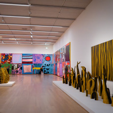 A long gallery of Kusama's tentacle sculptures, pumpkin and late paintings