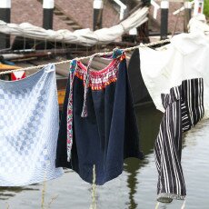Traditional Zuiderzee clothing drying on a washing line above the water at the museum