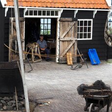 Ropemaker at work in a black timber workshop at the Zuiderzeemuseum, Enkhuizen