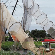 Fyke fishing nets hung out to dry beside the water in the Zuiderzeemuseum open-air village