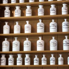 Labelled apothecary bottles on the shelves of the pharmacy at the Zuiderzeemuseum