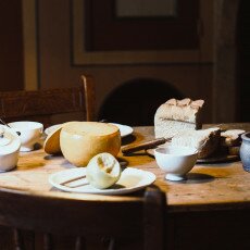 Cheese and bread laid out on the table in a reconstructed Zuiderzee house interior