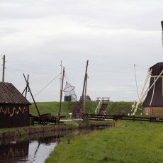 Windmill and fish-smoking house beside the canal in the Zuiderzee Village, Enkhuizen