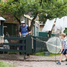 Costumed interpreter with a donkey by the Urk houses at the Zuiderzeemuseum, Enkhuizen