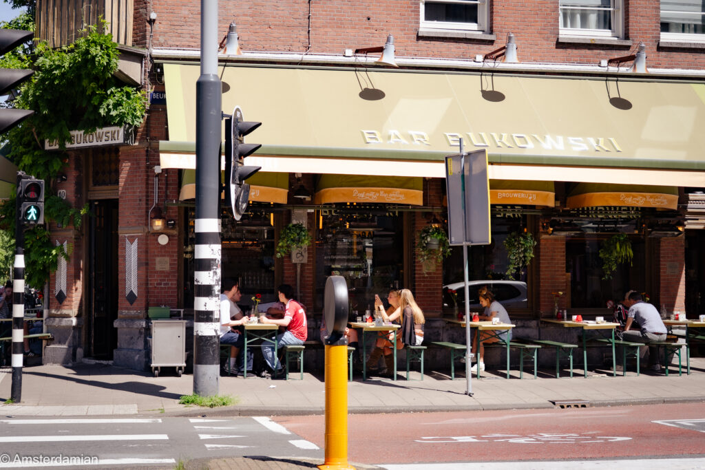 People sitting outside at Bar Bukowski on a sunny day