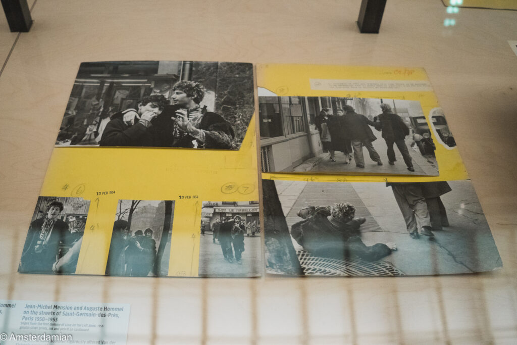 Yellow-paged book dummies in a display case, pasted with street photographs taken in Saint-Germain-des-Pres, Paris, in the early 1950s.