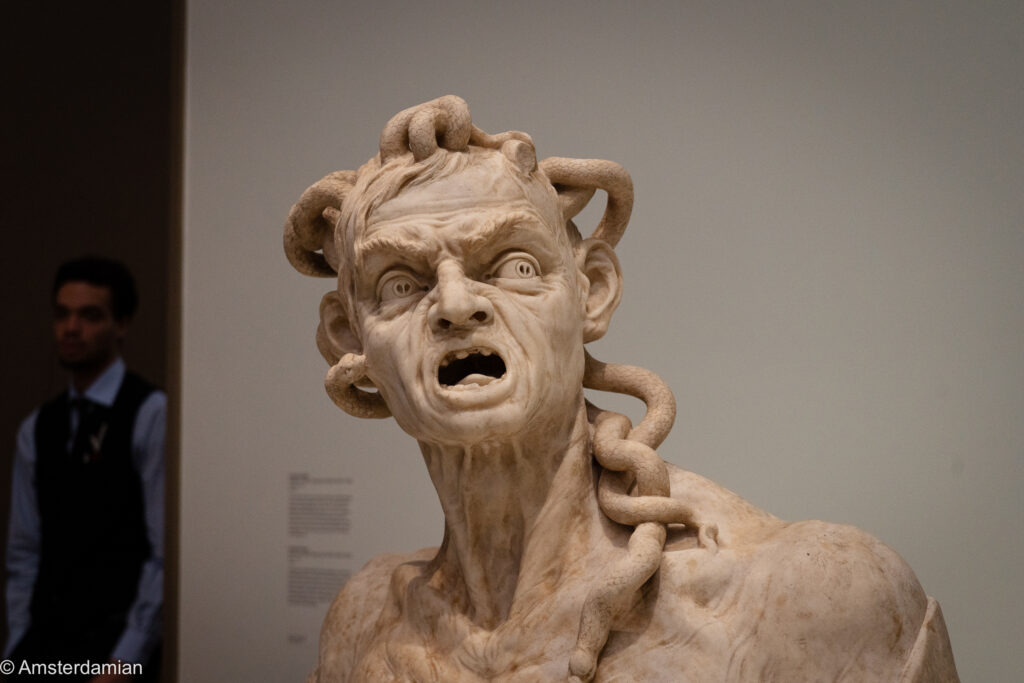 Marble bust of a screaming figure with snakes coiling through its hair, Envy by Giusto Le Court