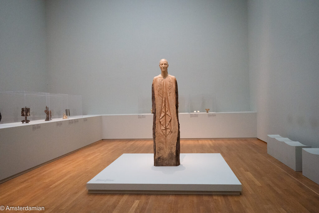 Femmy Otten's sculpture of a woman emerging from a tall tree trunk, the bark left rough at the sides