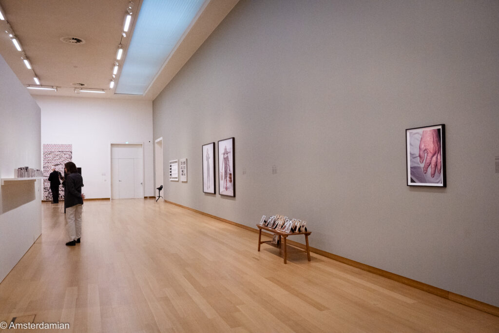 Stedelijk gallery with photographic works and a bench of framed pictures