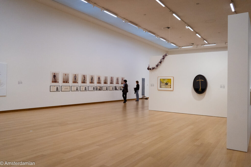 Exhibition room at the Stedelijk with Hans Eijkelboom's photo series on the left wall