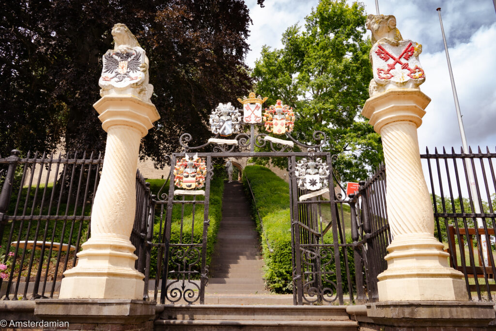 Decorative stone gate with coats of arms leading up to the Burcht, Leiden's medieval citadel mound
