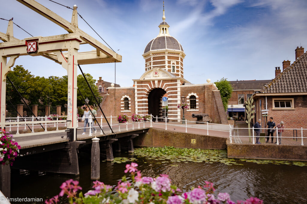 The domed Morspoort city gate with its white wooden drawbridge over the canal in Leiden