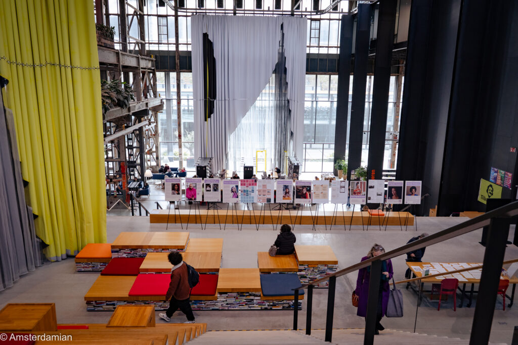 Interior of the LocHal in Tilburg with hanging textile curtains and tiered seating